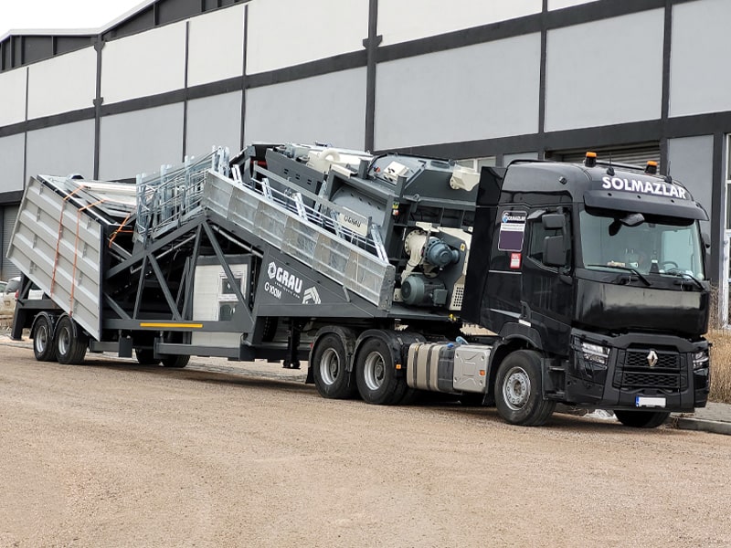 GRAU G100M mobile concrete plant in transport position in grey colour near the factory